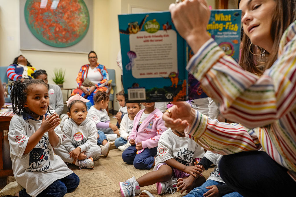Children listen to a reading at the Wilson Building.
