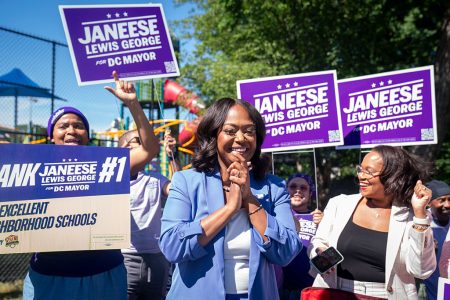 Janeese Lewis George with volunteers outside a voting station.