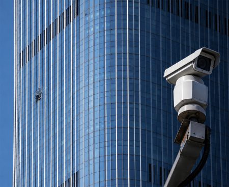 Security camera near damaged CITIC Tower section.