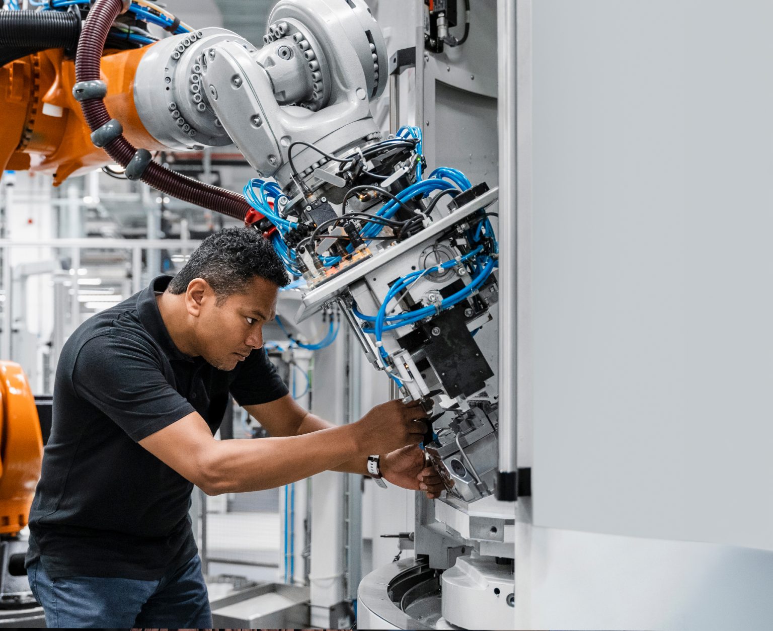 A worker attends to a robotic arm in Germany.