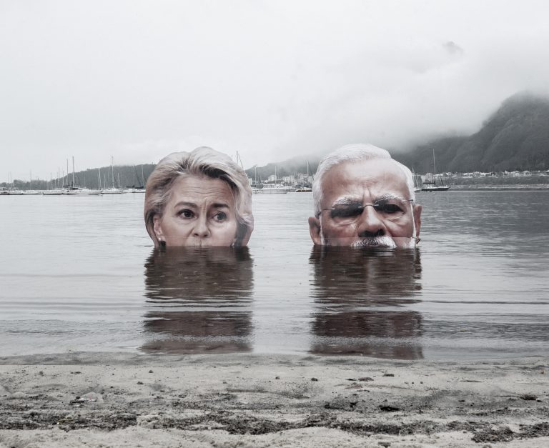 Portraits of Ursula von der Leyen and Narendra Modi at a protest.