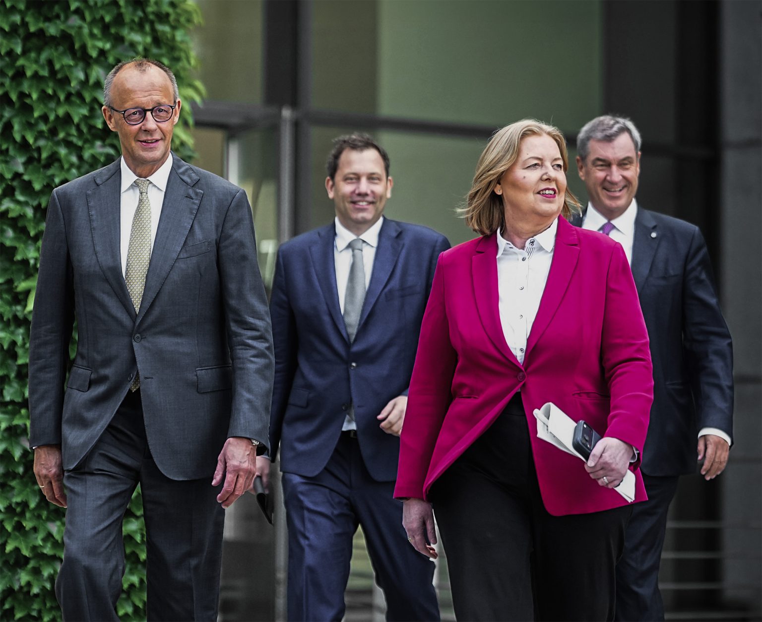 Friedrich Merz, Lars Klingbeil, Bärbel Bas, and Markus Söder arrive for a press conference.