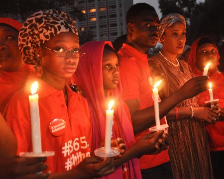 Participants hold candles at a vigil in Abuja.