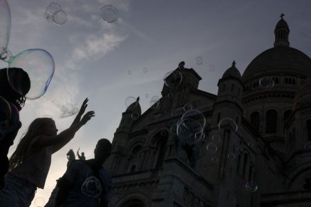Children playing with bubbles outside the Sacre-Coeur Basilica.
