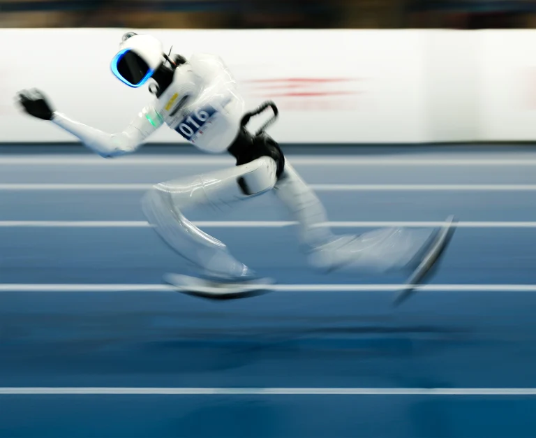 Humanoid robots at a track and field event.