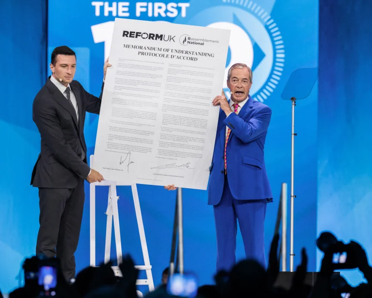 Nigel Farage and Jordan Bardella with a memorandum of understanding.
