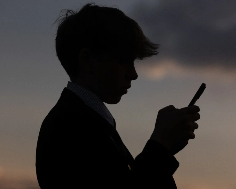 Boy scrolling on his smartphone.